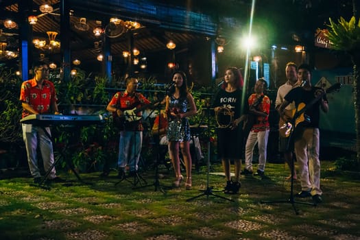 MUI NE, VIETNAM - CIRCA MARCH 2017: Street musicians perform at night