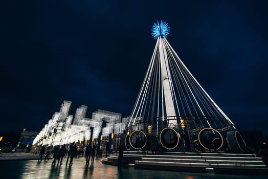 MOSCOW, RUSSIA - DECEMBER 25, 2016: Artificial Christmas fir illuminated at ENEA with visitors to Moscow. Russia