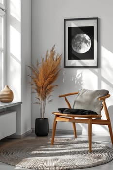 A chair is in a room with a plant and a framed picture of a moon. The room is well lit and has a cozy atmosphere