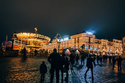 MOSCOW, RUSSIA - DECEMBER 23, 2016: Tourists on red Square in Moscow on the eve of new Year's eve at night in December