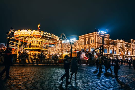 MOSCOW, RUSSIA - DECEMBER 23, 2016: Tourists on red Square in Moscow on the eve of new Year's eve at night in December
