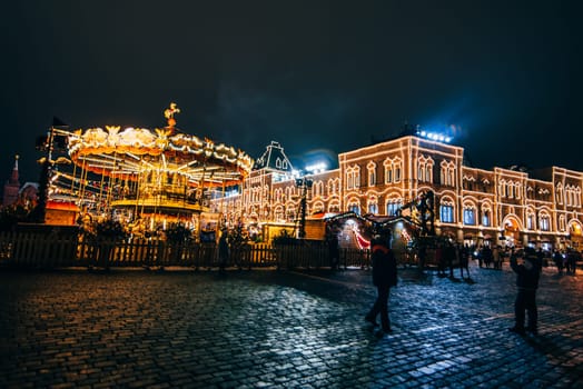 MOSCOW, RUSSIA - DECEMBER 23, 2016: Tourists on red Square in Moscow on the eve of new Year's eve at night in December