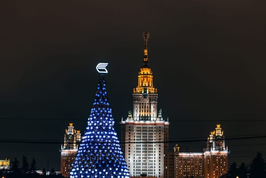 MOSCOW, RUSSIA - DECEMBER 25, 2016: Lomonosov Moscow State University on the background of the Christmas tree, Russia