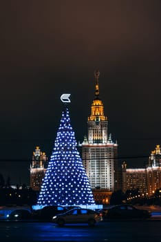 MOSCOW, RUSSIA - DECEMBER 25, 2016: Lomonosov Moscow State University on the background of the Christmas tree, Russia