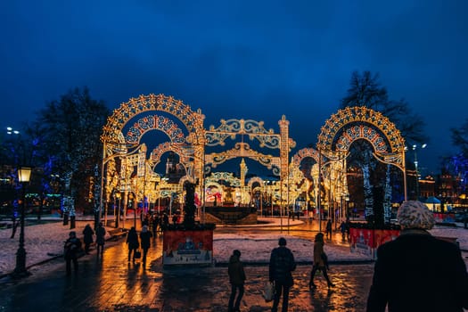 MOSCOW, RUSSIA - DECEMBER 23, 2016: Decorated new year's streets of Moscow at night with people