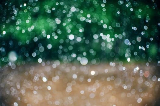 defocused glowing raindrops with blurred abstract green background