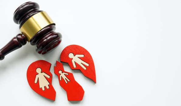 Broken heart with family as a divorce concept and gavel symbolizing the law.