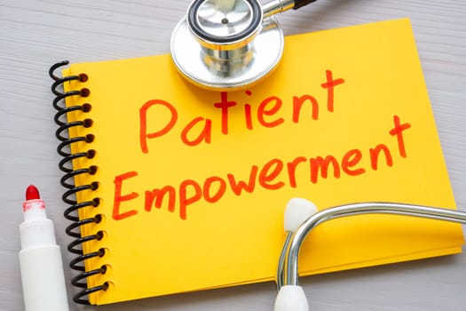 Patient empowerment concept. Mark on notepad and stethoscope.