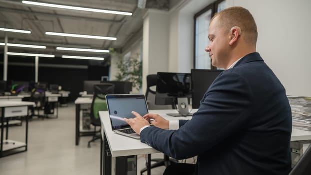 Caucasian deaf man communicates in sign language on laptop in office