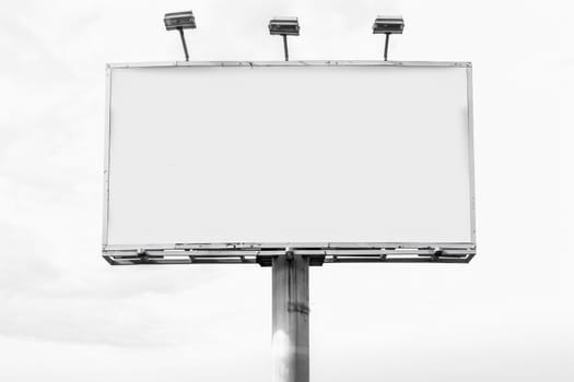 blank white billboard with lithts on white background.