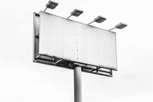 blank white billboard with lithts on white background.