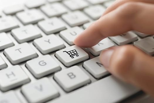 A person is pointing to a shopping cart key on a keyboard.