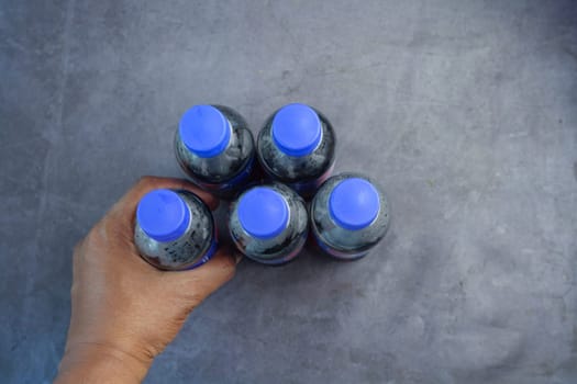 plastic bottles of soft drink on table .
