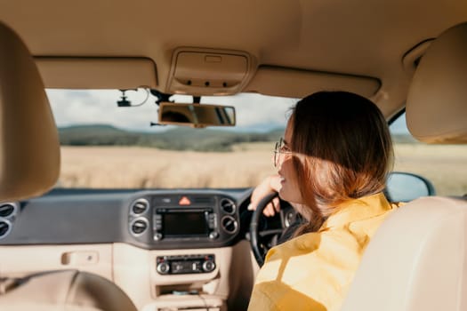 Relaxed business woman talking on video call on phone in automobile. Rested female professional saying bye on video chat in business car. Beautiful lady making video message in luxury car.