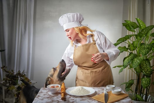 Fat funny female cook in a hat and apron in the kitchen with big shepherd dog. Good cooking, body positive, pet