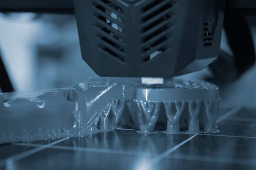 3D printer printing object close-up. Process creating three-dimensional model on 3d printer. Additive printer technology. 3D Prototyping. 3D design modeling. New modern innovation printing technology