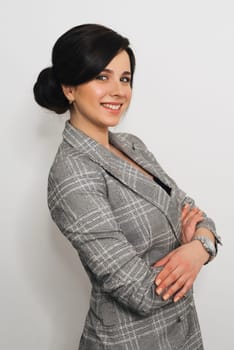 young businesswoman in business suit on light background. Girl Secretary of Caucasian appearance with attractive smile