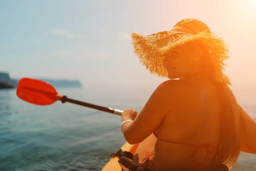 A woman wearing a straw hat is paddling a canoe on a sunny day. Scene is relaxed and carefree, as the woman enjoys her time on the water