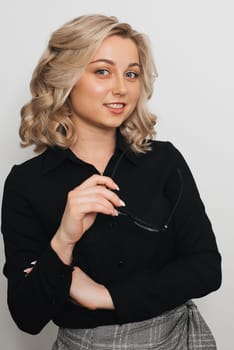 young business girl with glasses in hand in business suit with attractive happy smile