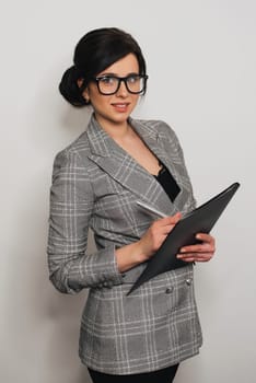 happy businesswoman girl with documents in business suit with glasses smiling
