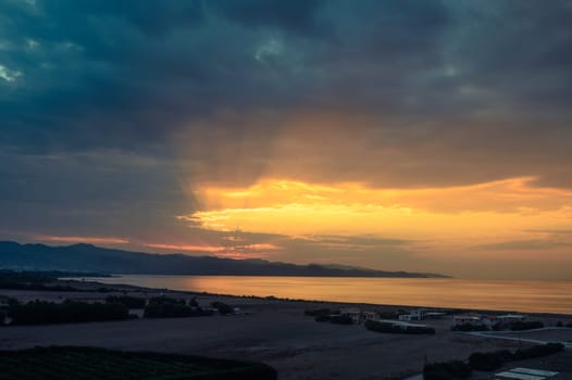 sunset over the Mediterranean sea, sun rays through the clouds 1