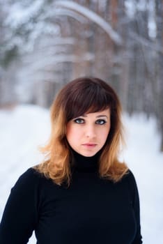 portrait of beautiful girl in winter forest