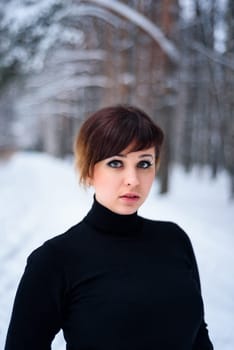 portrait of beautiful girl in winter forest