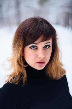 portrait of beautiful girl in winter forest