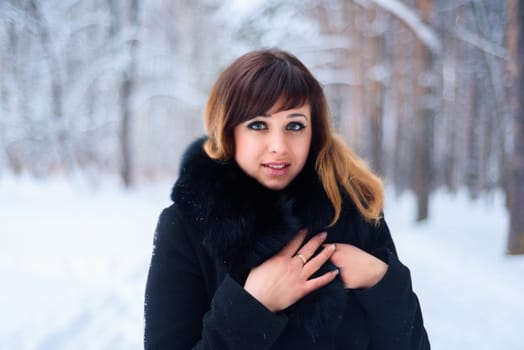 portrait of beautiful girl in winter forest