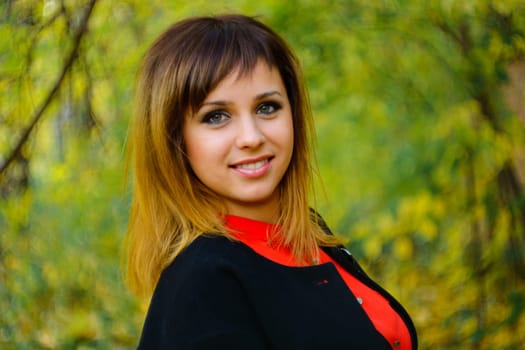 portrait of girl Caucasian appearance smiling in the forest in autumn