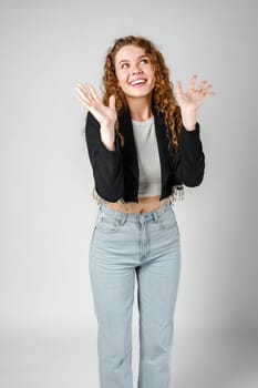 Young Businesswoman Gesturing Excitement or Surprise Against a Neutral Background close up