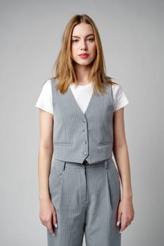 Young Woman Wearing Gray Suit and White Shirt on gray background