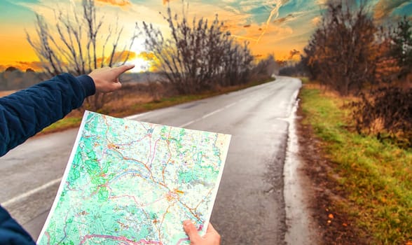 A man looks at a map on the road. Selective focus. People.