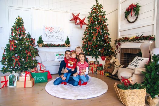 Family photo near the Christmas tree. Selective focus. Holiday.