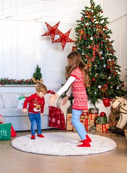 Children near the Christmas tree. Selective focus. Kid.