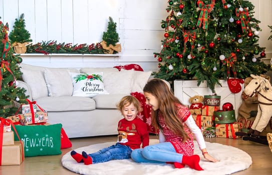 Children near the Christmas tree. Selective focus. Kid.