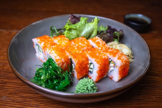 rolls with red caviar, wasabi, nori on a plate. Japanese kitchen.