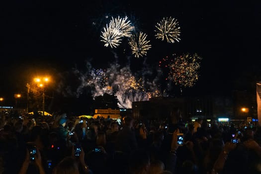 KINESHMA, RUSSIA - AUGUST 30, 2018: Colorful fireworks in the night sky and the crowd at the concert in Kineshma