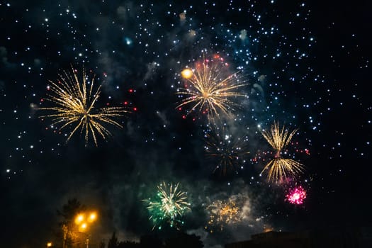 Festive bright colored fireworks on background a dark night sky