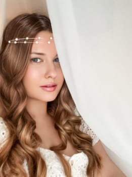 Beautiful bridal look, bride with long hair, wearing pearl tiara jewellery and beauty makeup, woman with curly hairstyle, face portrait for wedding and fashion style idea