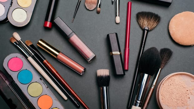 professional makeup and facial beauty kit. Brushes, lipstick, eye shadow, powder. Top view