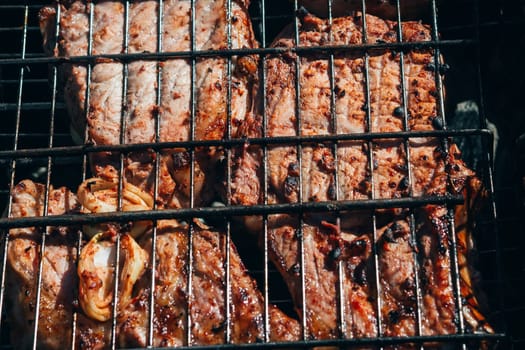 pork meat fried on a barbecue grill close-up