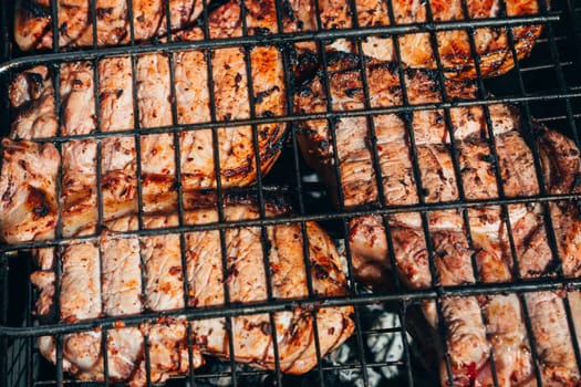 pork meat is cooked on the grill on the coals close-up