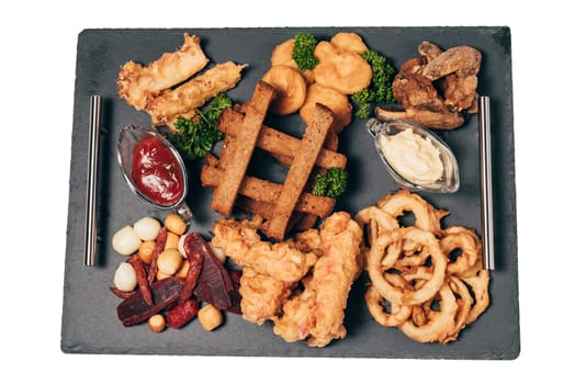 set of snacks for beer from crackers, onion rings, sausage and cheese and sauce