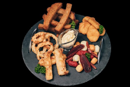 set of snacks for beer from crackers, onion rings, sausage and cheese and sauce