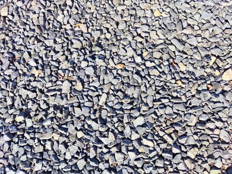 Stone asphalt texture of road in a day. Grey asphalt road and gravel. Background pebble and gravel