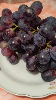 red dark grapes fruit on a plate. High quality photo