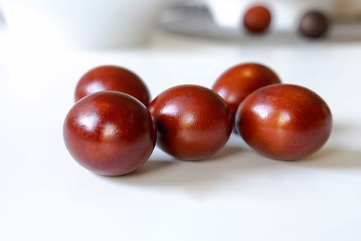 Chicken eggs painted red for Ester on white. High quality photo