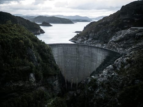 View of the Gordon Dam on a cool summer's day. It is a unique double curvature concrete arch dam with a spillway across the Gordon River near Strathgordon, South West Tasmania, Australia