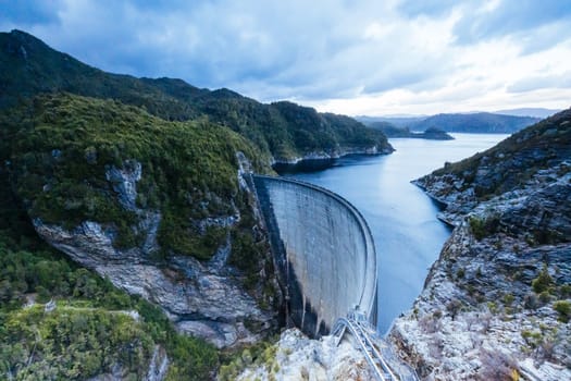 View of the Gordon Dam on a cool summer's day. It is a unique double curvature concrete arch dam with a spillway across the Gordon River near Strathgordon, South West Tasmania, Australia